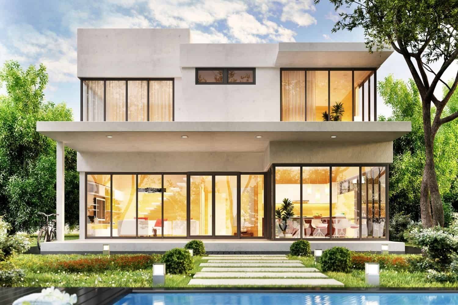 A modern house with a swimming pool in the backyard surrounded by trees.