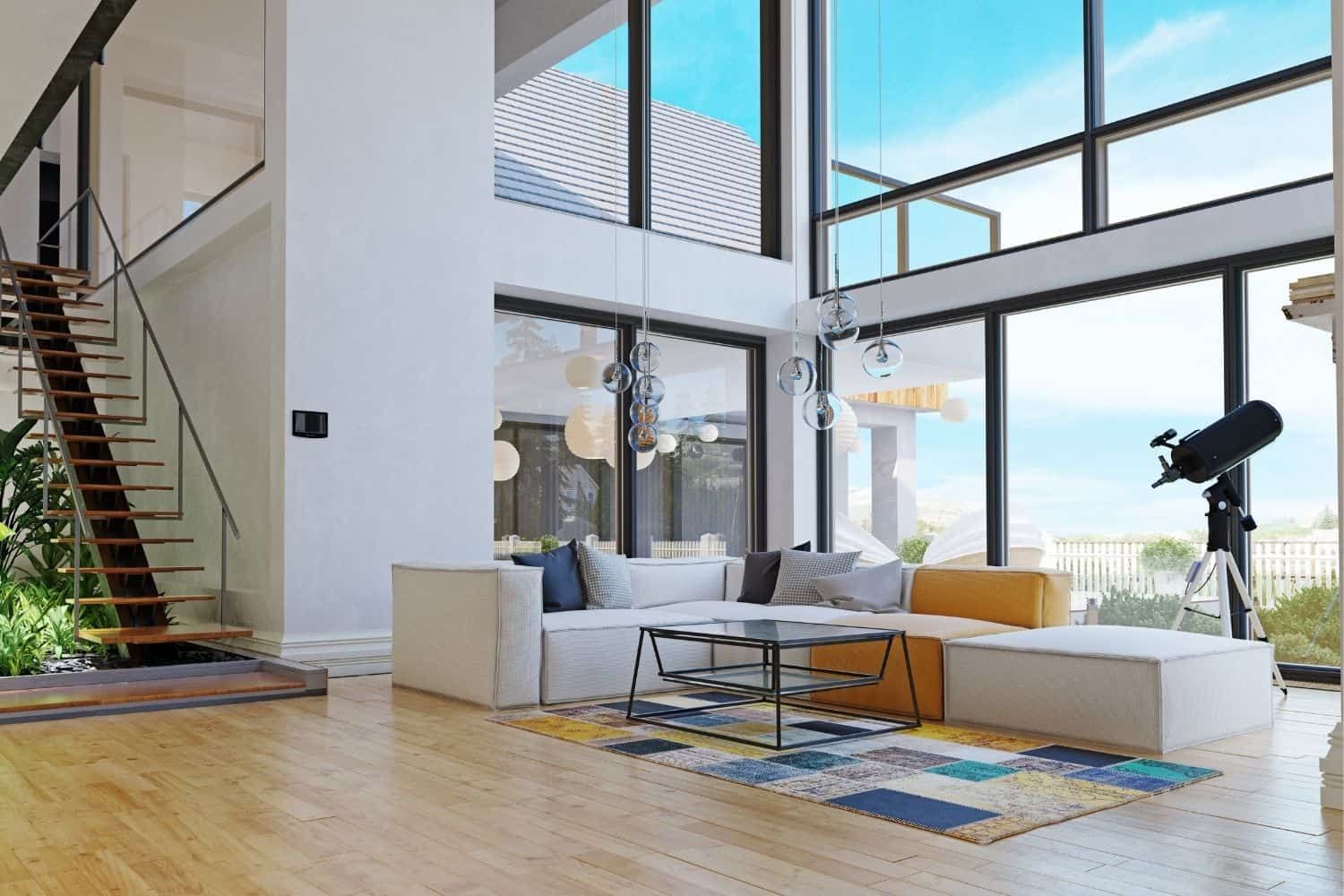 It is a living room with a lot of windows and a telescope.