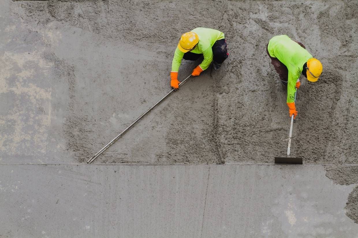 a man is using a paint roller to paint the floor