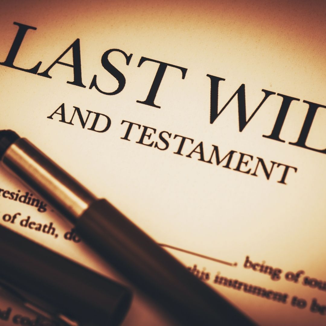 Close-up of a Last Will and Testament document with a pen.