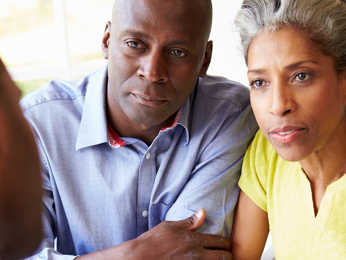 Man and woman looking at something, both with serious expressions.