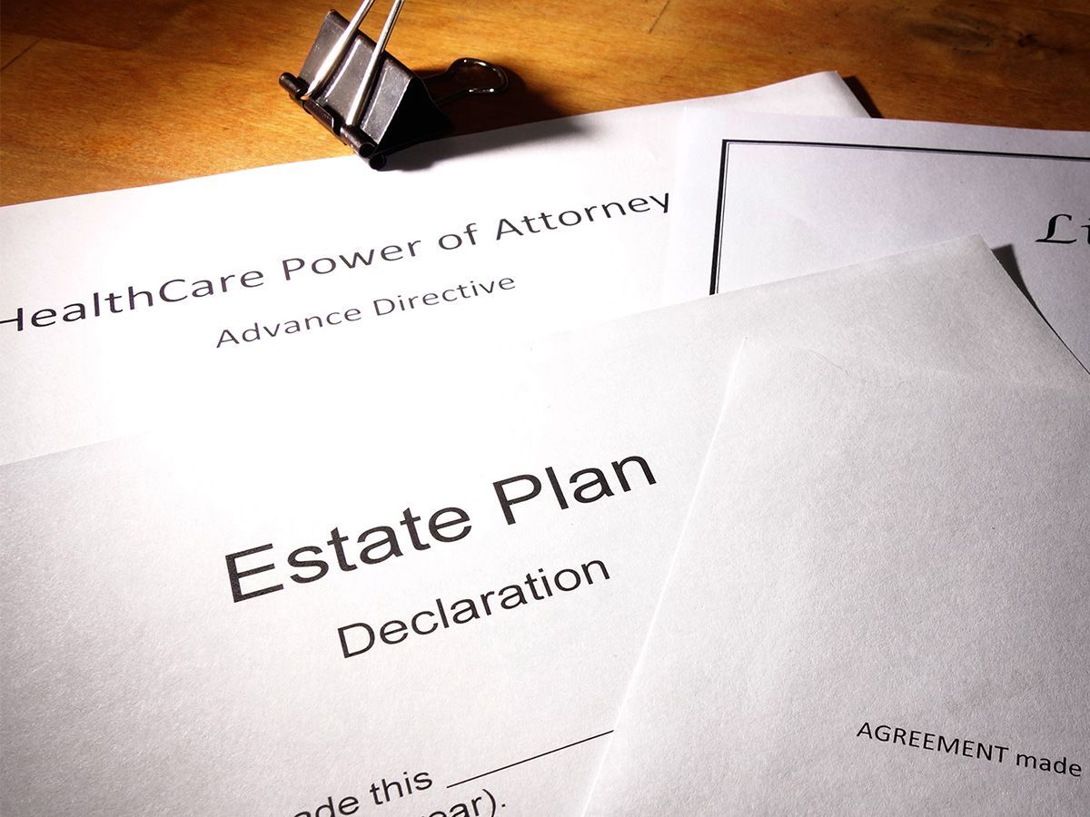 Stack of legal documents: Healthcare Power of Attorney, Estate Plan Declaration, clipped together.