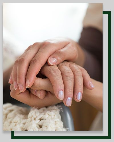 Two hands, one older, clasped together, possibly offering comfort and support.
