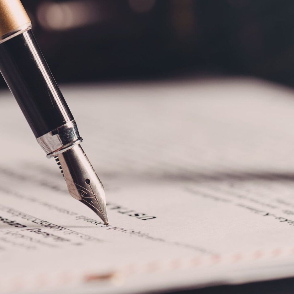 Fountain pen writing on a document, close-up shot.