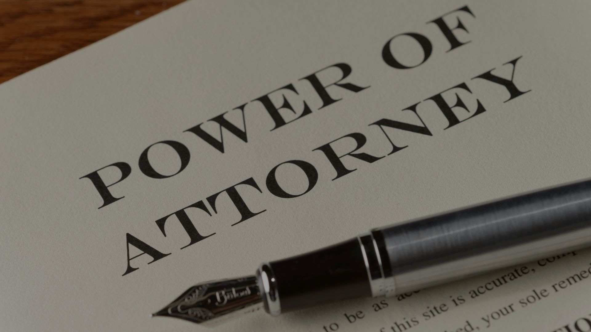 Power of Attorney document with a pen, close up.