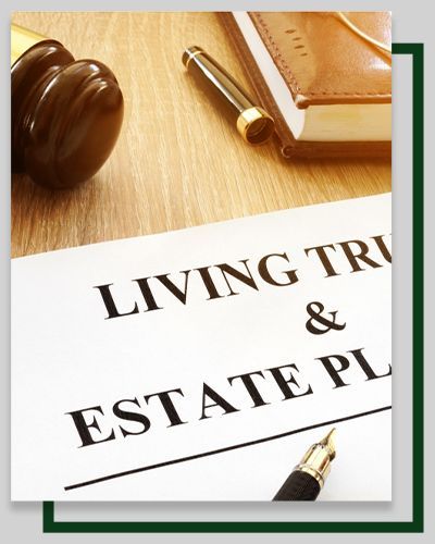 Living trust and estate planning document with a gavel, pen, and notebook on a wooden desk.