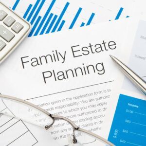 Family Estate Planning document with a calculator, pen, and glasses on a desk.
