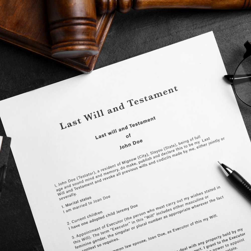 Last Will and Testament document on a desk, with a gavel and glasses.
