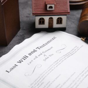 Last Will and Testament document with a miniature house and gavel.