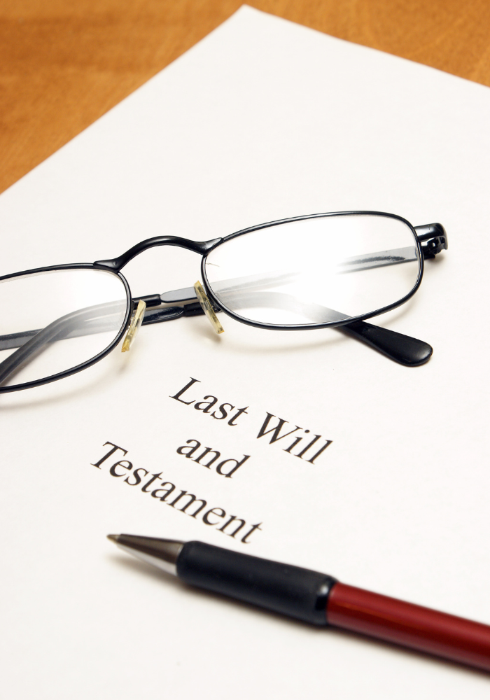 Last Will and Testament document with glasses and a pen.