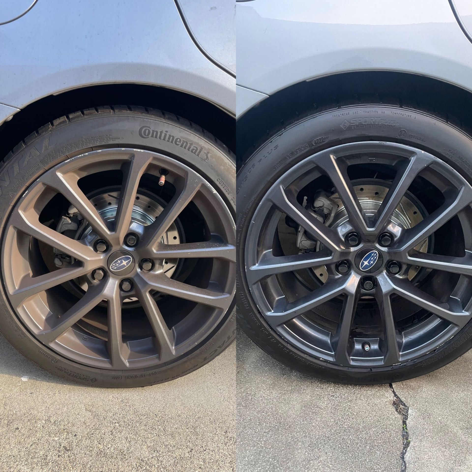 Two car wheels with dark alloy rims parked on pavement, showing the rear quarter panel.
