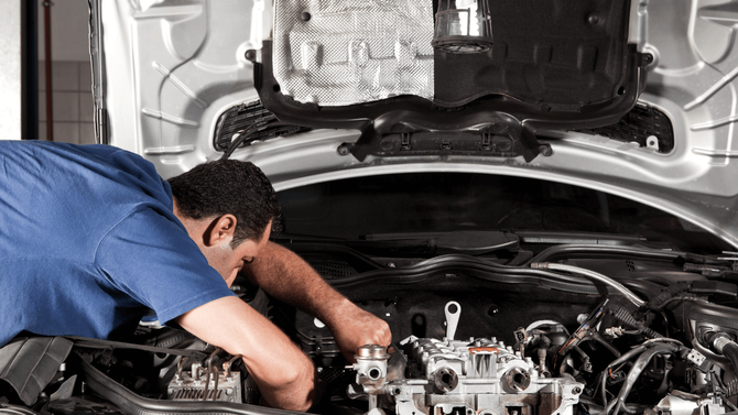 Mechanic under the hood of a car