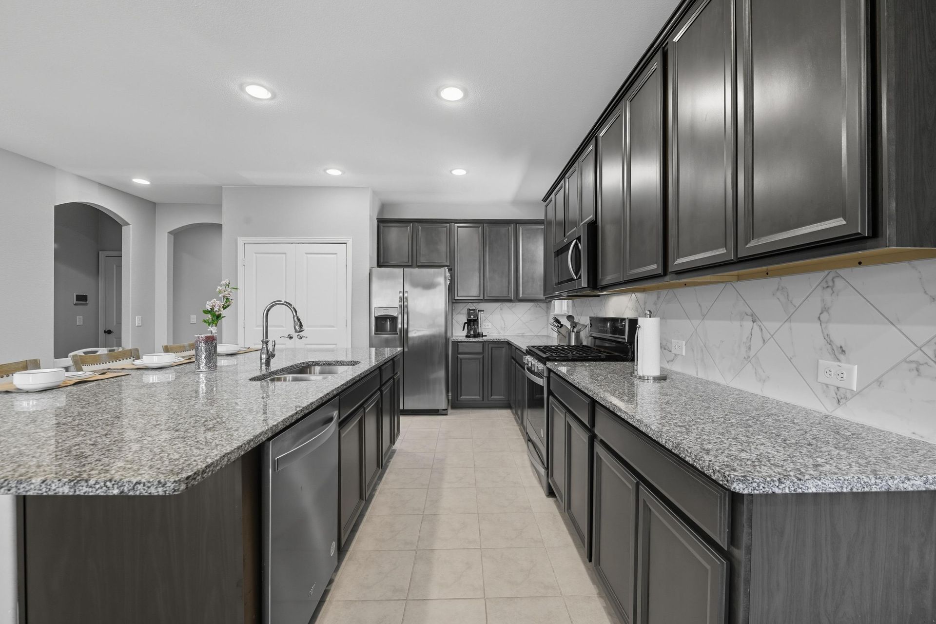 A patio with a lot of furniture and lights at night.