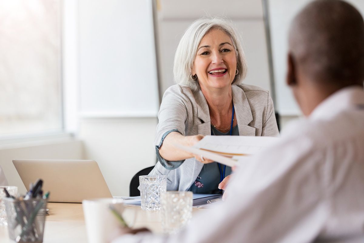 Woman hands a document — Kent, OH — Turner & Sly Insurance Agency