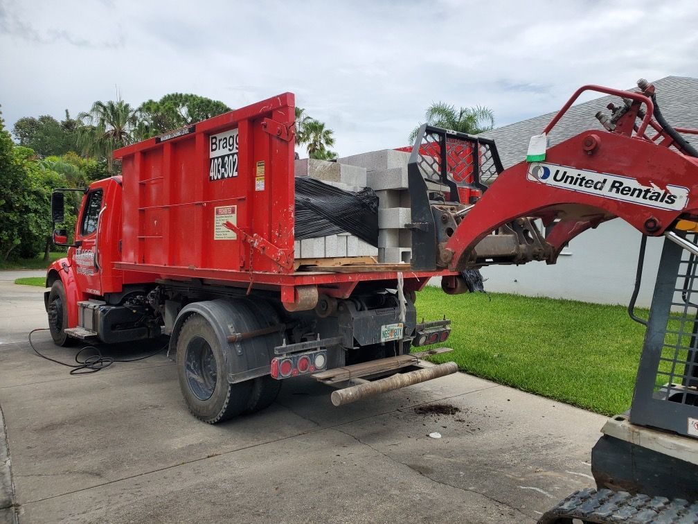 Unloading Dumpster Truck — Melbourne, FL — Braggs Roll-Off Dumpsters Inc.
