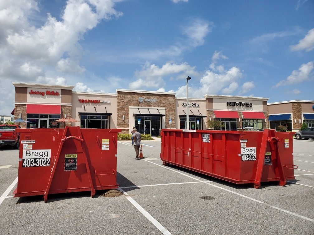 Two Red Dumpsters — Melbourne, FL — Braggs Roll-Off Dumpsters Inc.