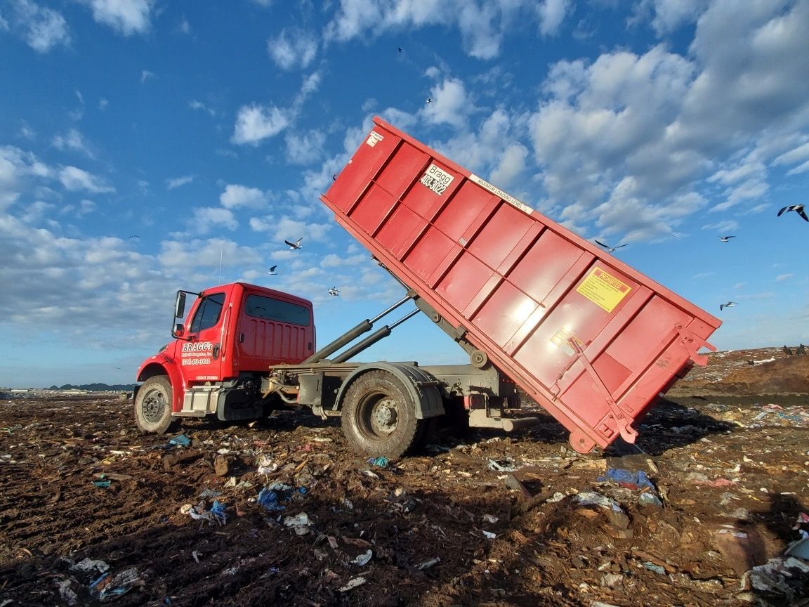 Dumpster Truck on a Landfill — Melbourne, FL — Braggs Roll-Off Dumpsters Inc.