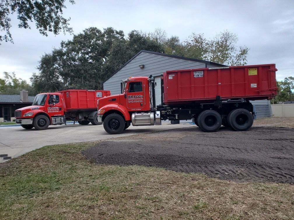 Two Dumpster Trucks — Melbourne, FL — Braggs Roll-Off Dumpsters Inc.