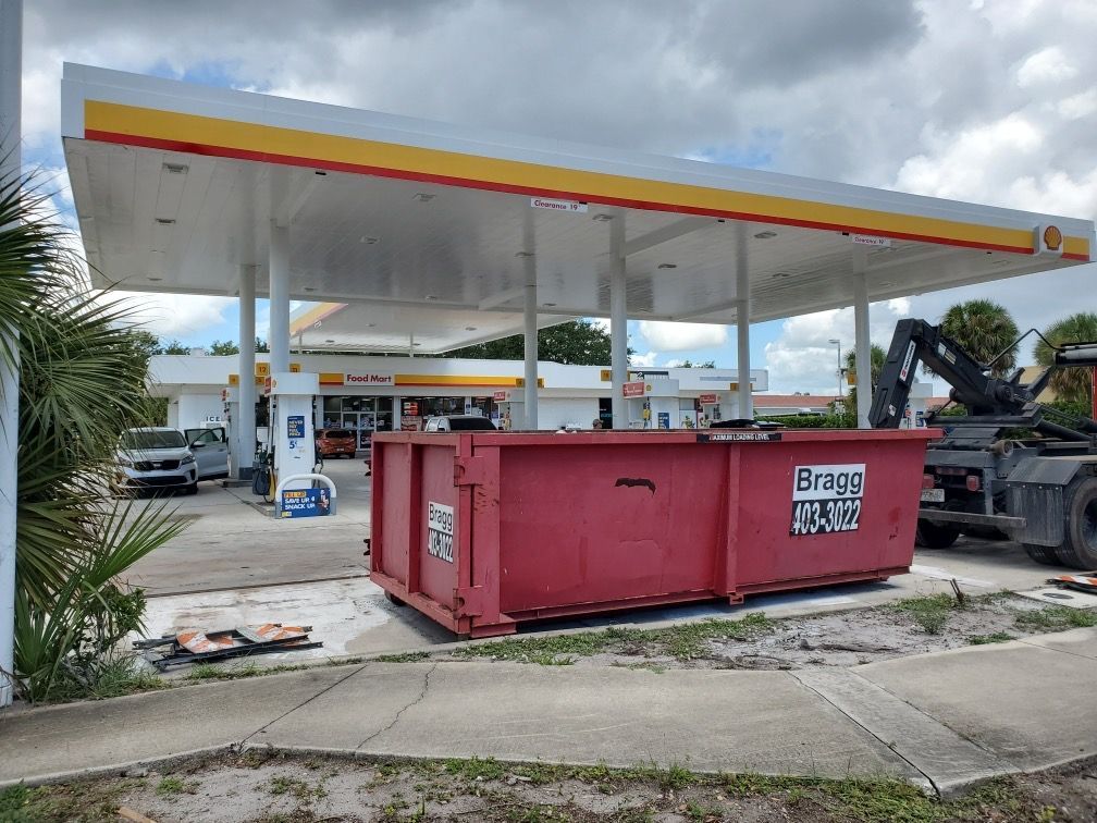 Dumpster at a Gas Station — Melbourne, FL — Braggs Roll-Off Dumpsters Inc.