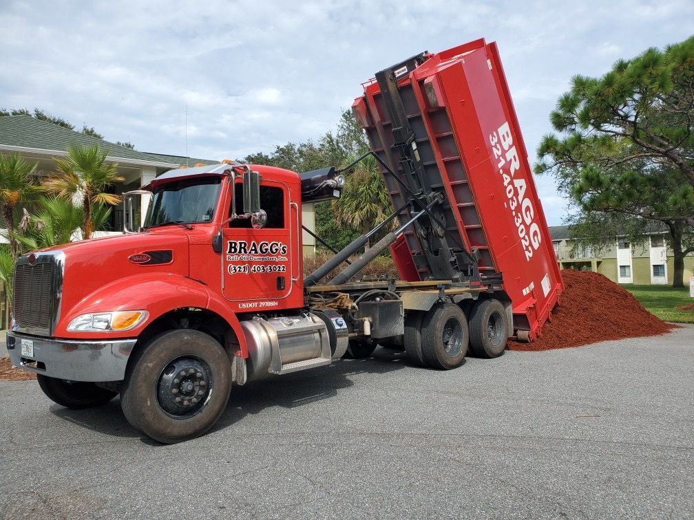 Dump Truck Unloading Soil — Melbourne, FL — Braggs Roll-Off Dumpsters Inc.