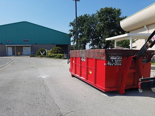 Residential Dumpster Rentals — Sideview of Red Truck in Melbourne, FL