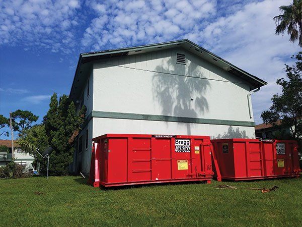 Dumpster Rentals — Sideview of Red Truck in Melbourne, FL