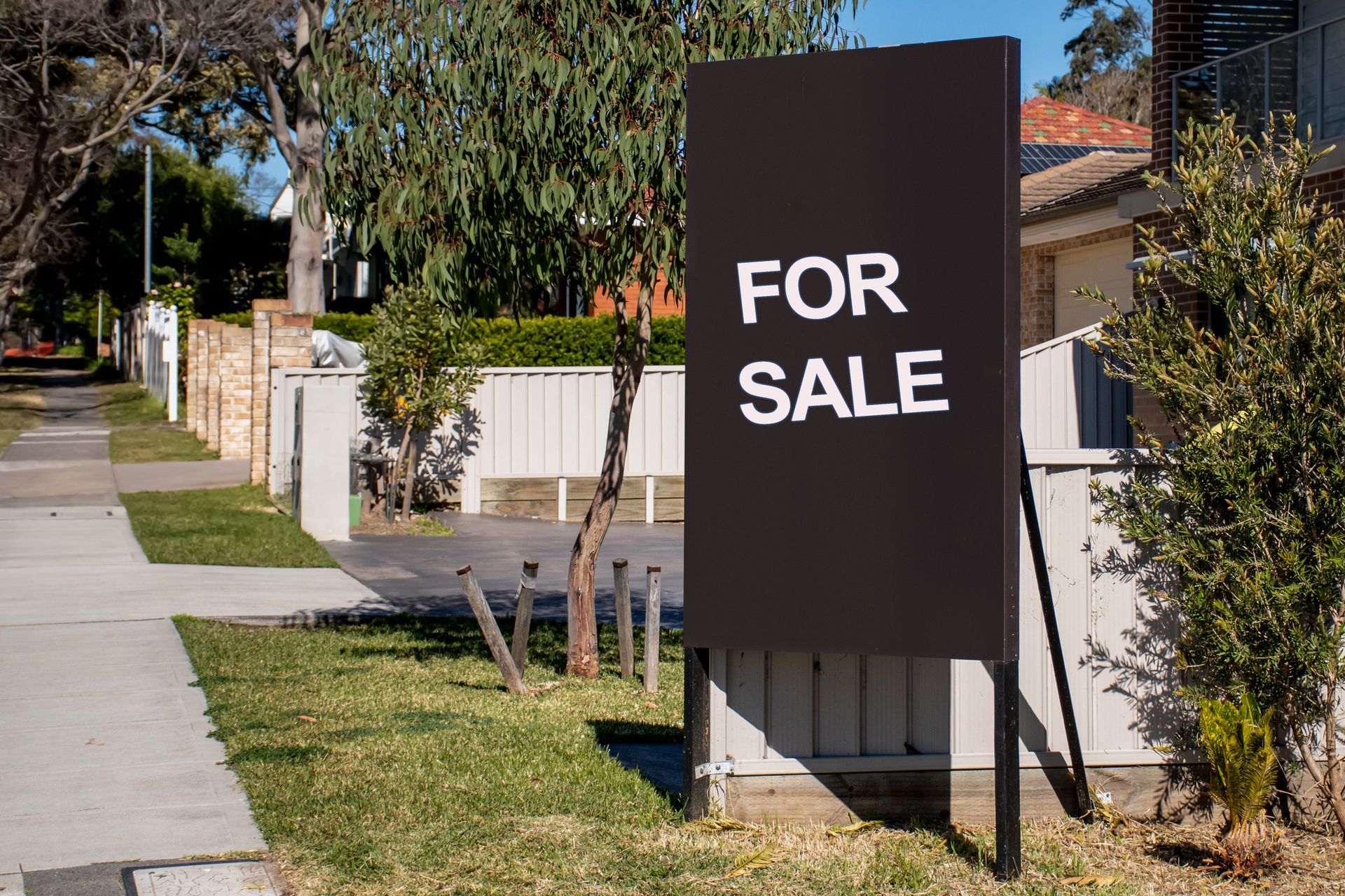 A for sale sign is sitting on the side of the road - Perth, WA - Allos Parakletos