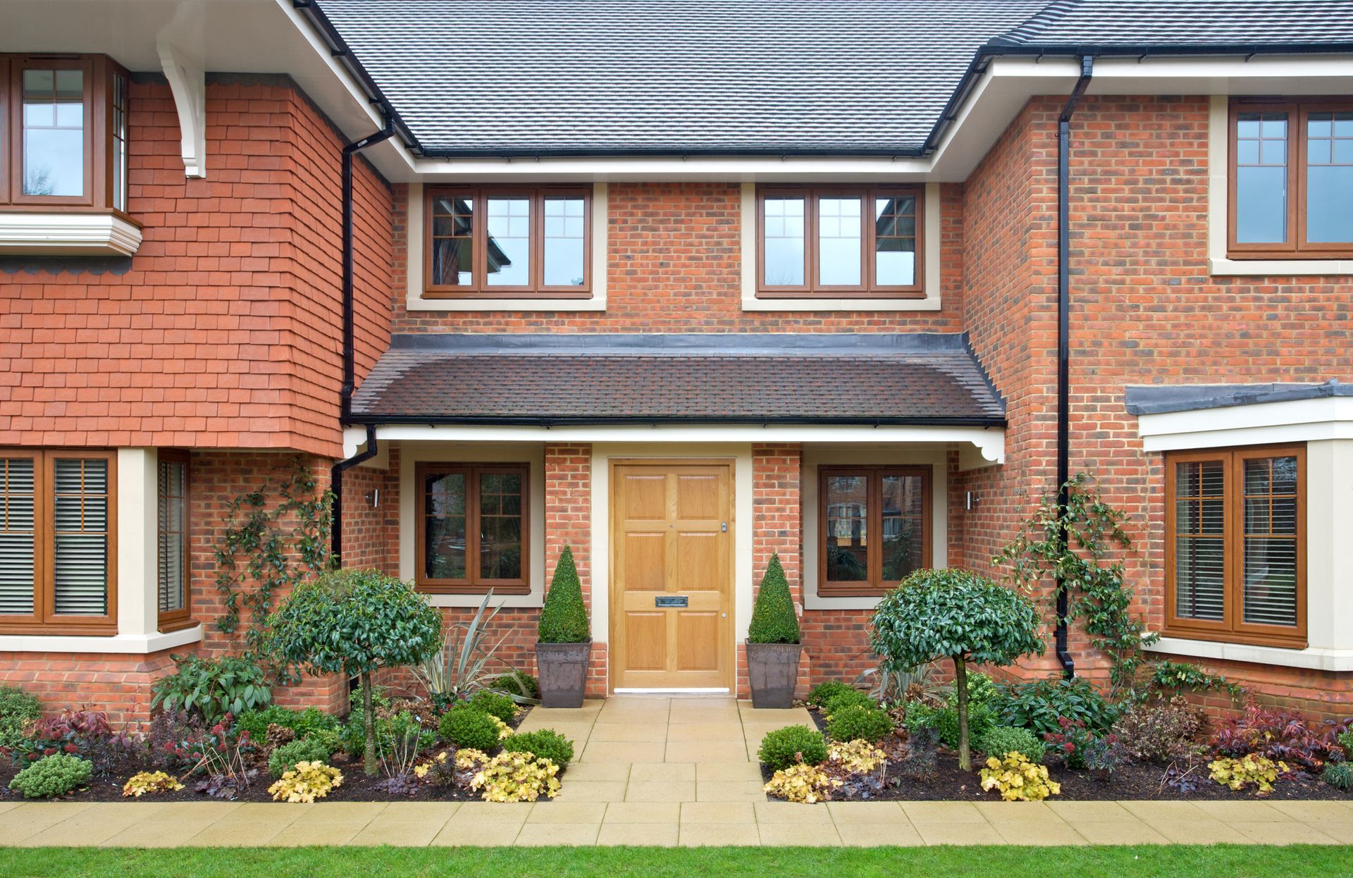 A large brick house with a wooden door and windows - Perth, WA - Allos Parakletos