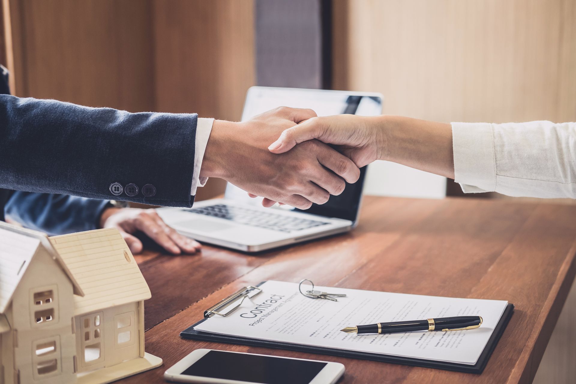 A man and a woman are shaking hands over a table - Perth, WA - Allos Parakletos