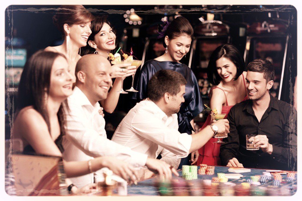 A group of people are sitting around a table in a casino.