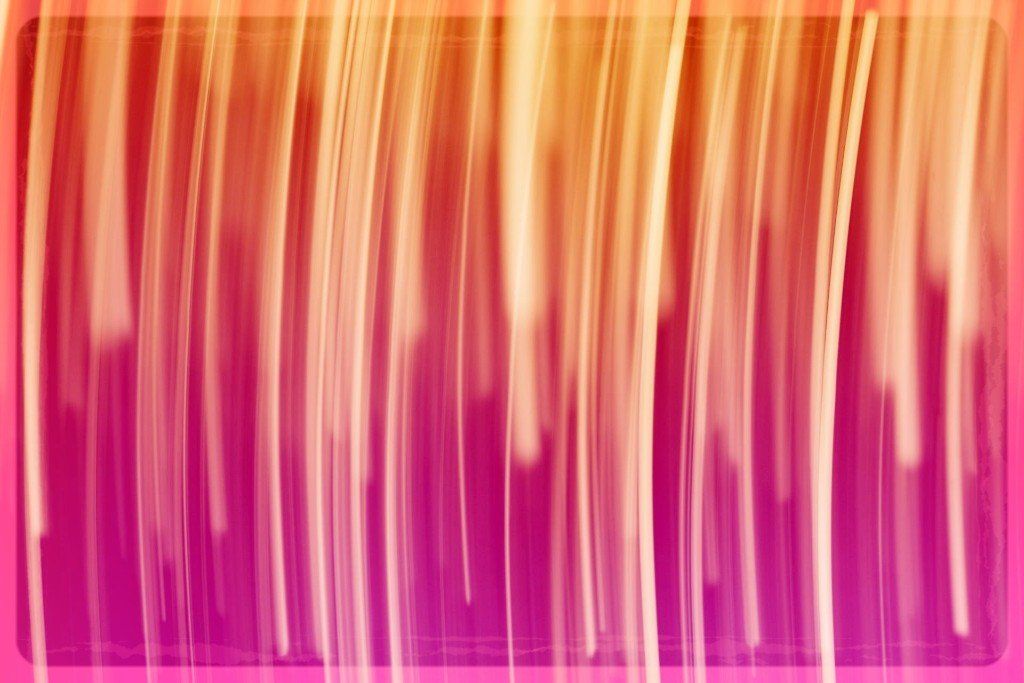A blurred image of a pink and orange background with vertical lines.