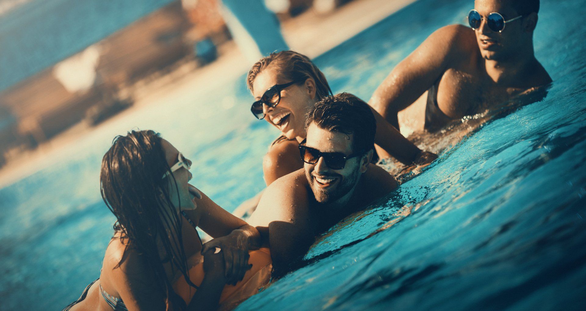A group of people are playing in a swimming pool.