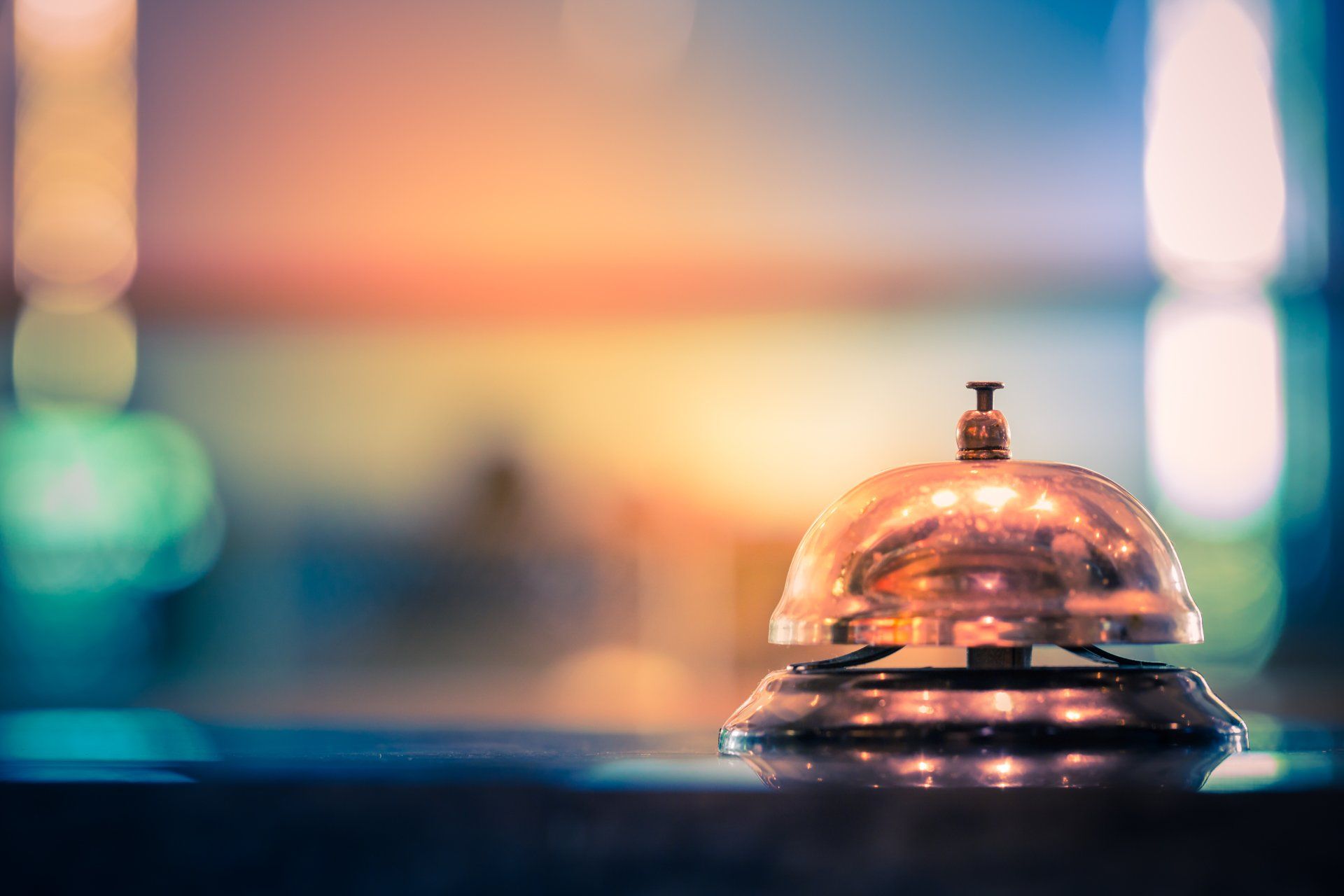 A close up of a hotel bell on a table.