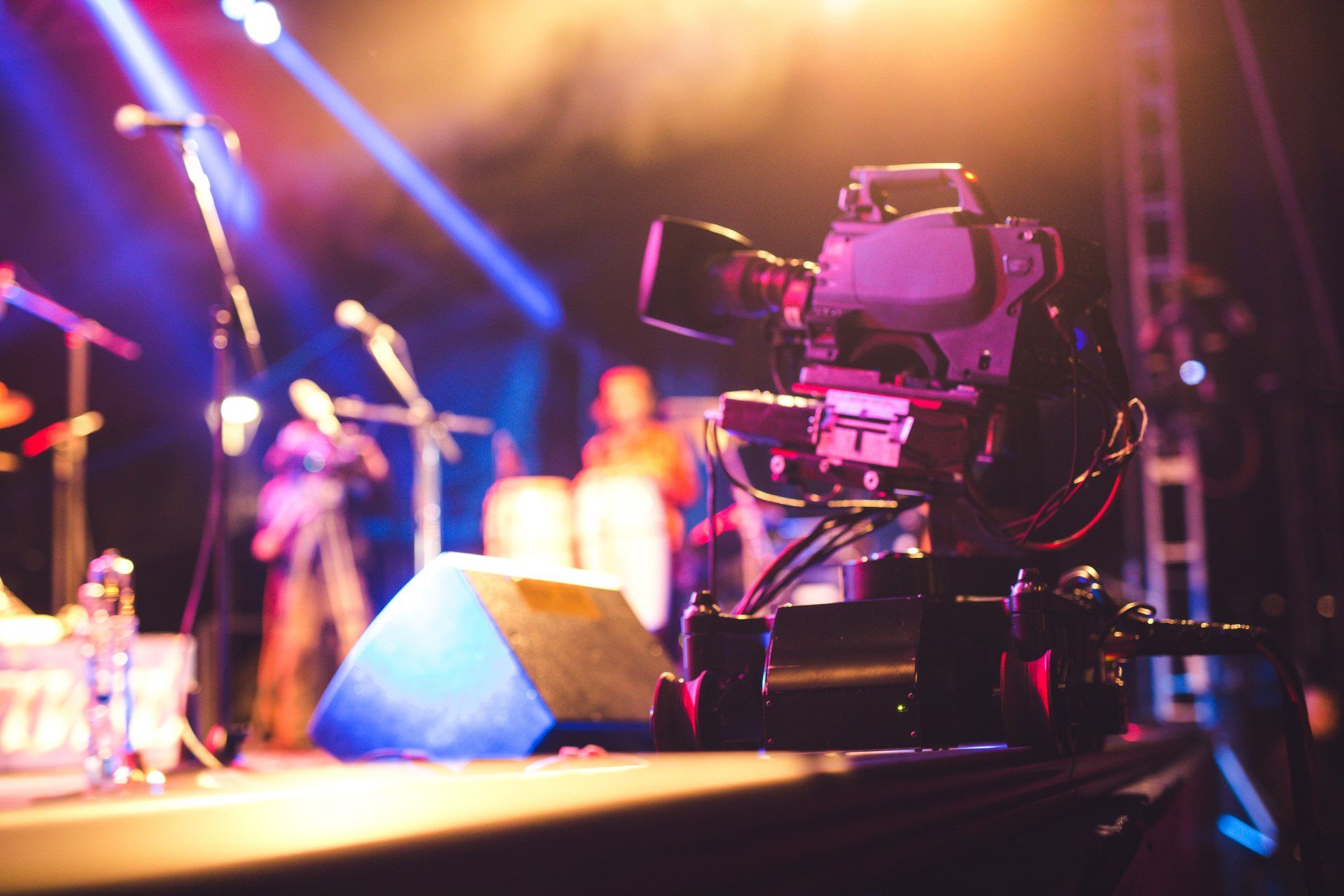 A camera is sitting on a stage at a concert.
