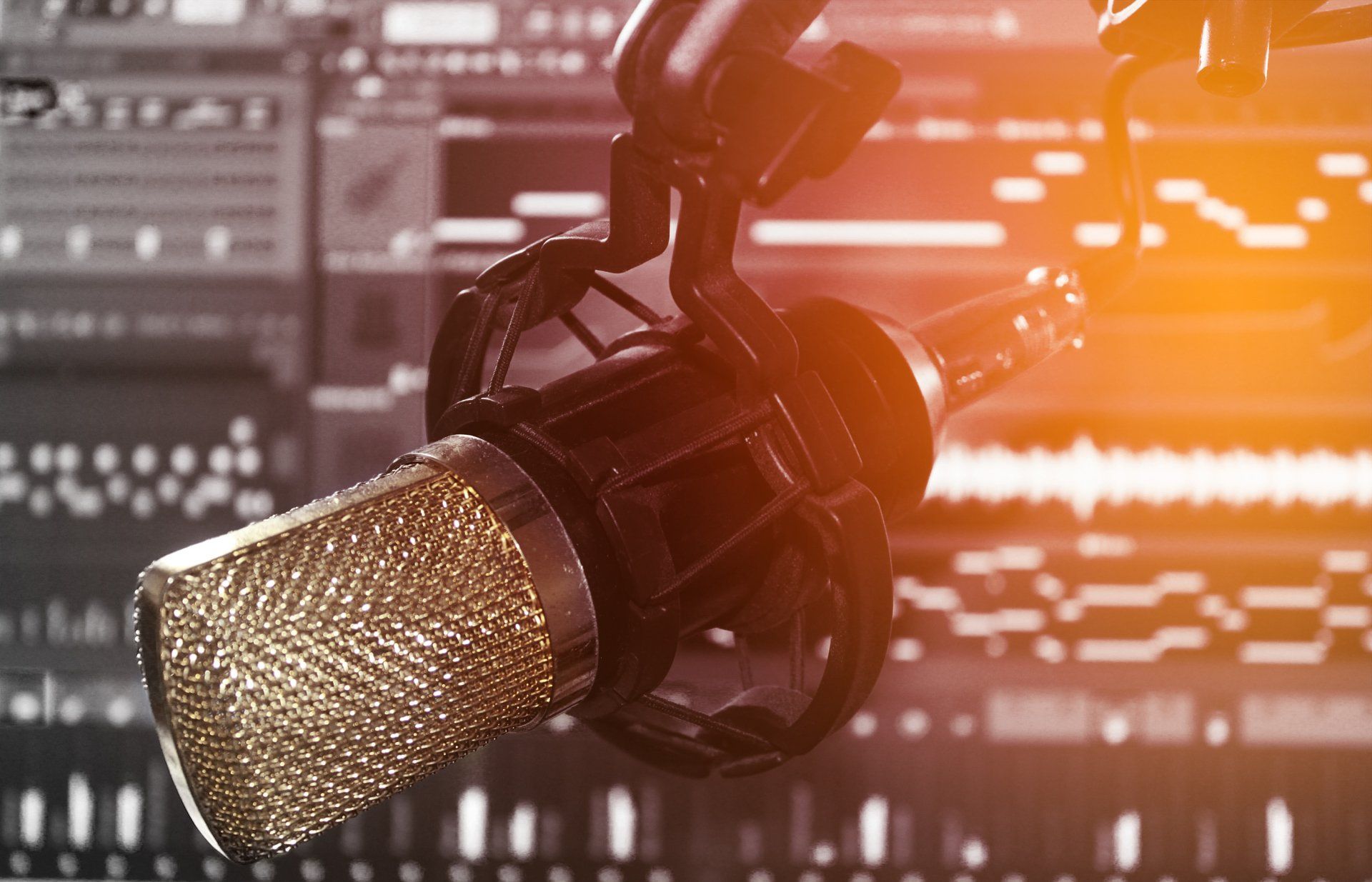 A close up of a microphone on a stand in a studio.