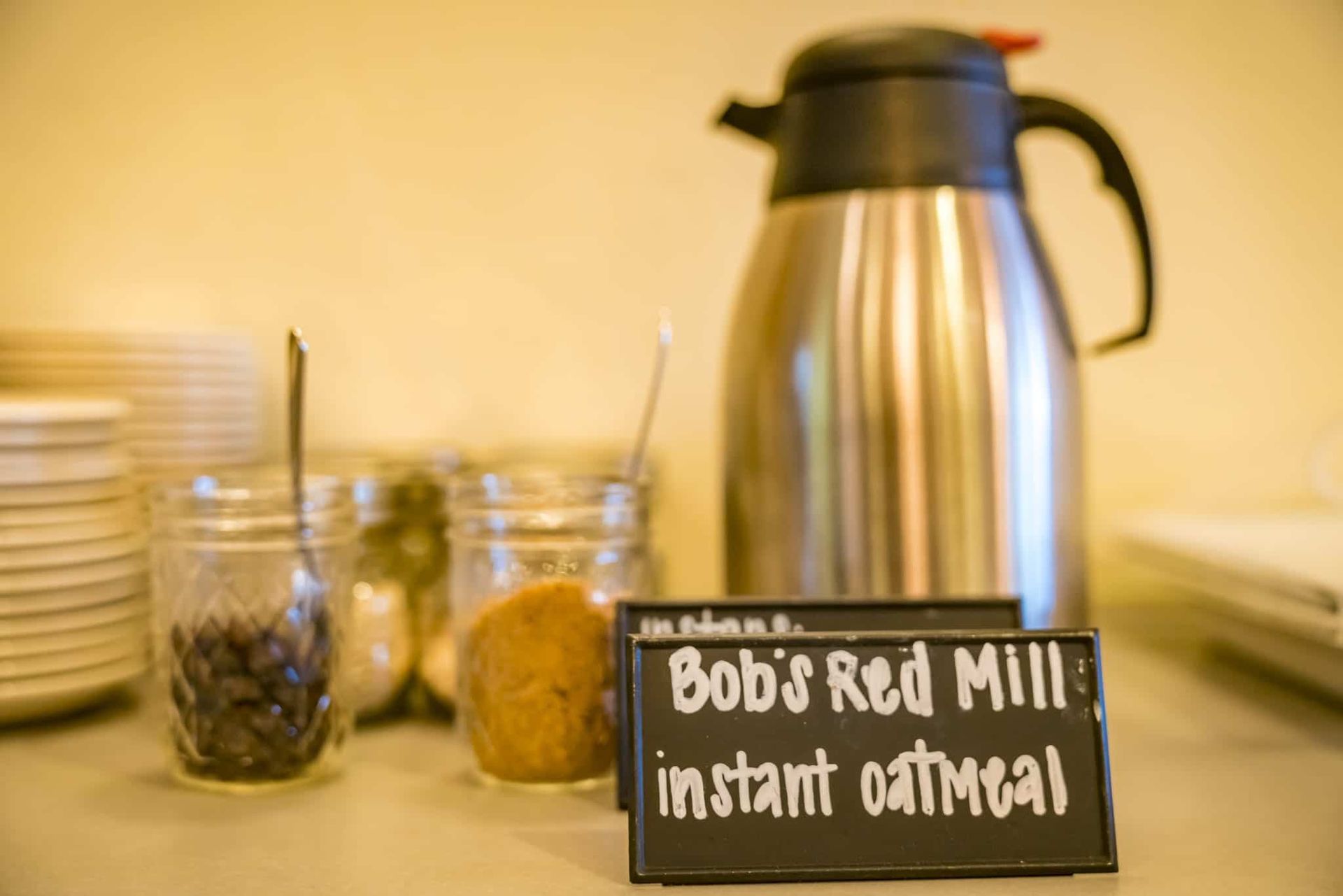 A buffet table with a sign that says bob 's red mill instant oatmeal.