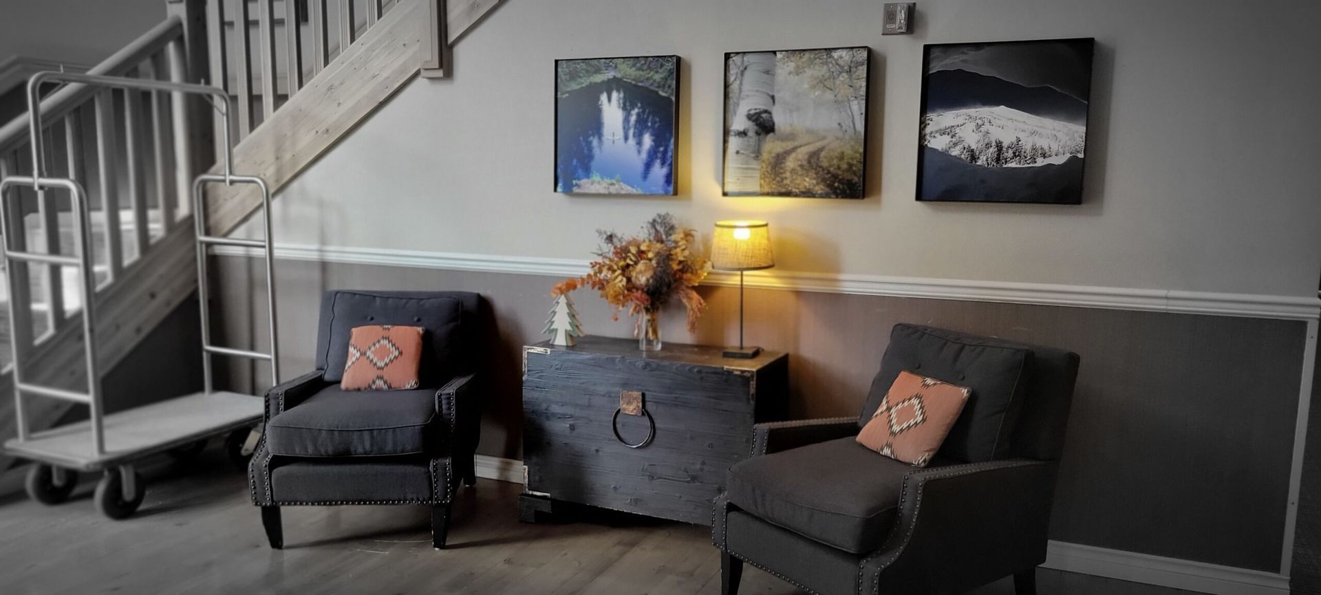 A living room with two chairs and a staircase in the background.