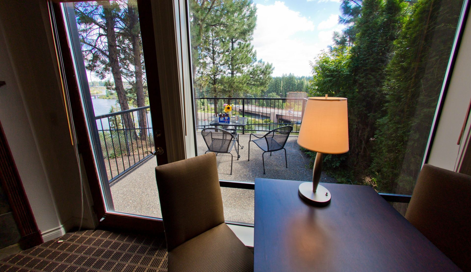 A room with a table and chairs and a lamp