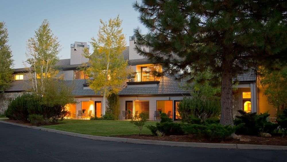 A large house with a lot of windows and trees in front of it.
