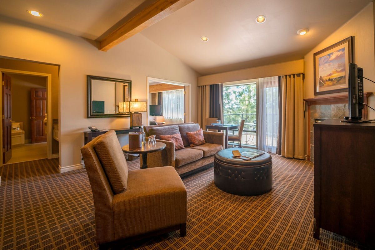 A living room with a couch , chair , table and television.