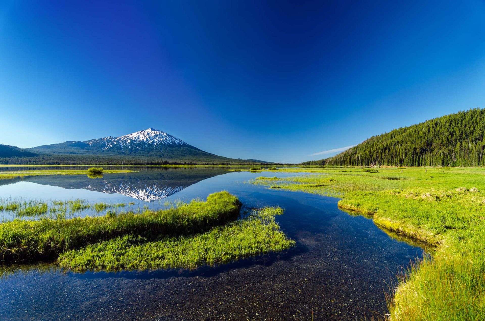 There is a mountain in the background and a lake in the foreground.