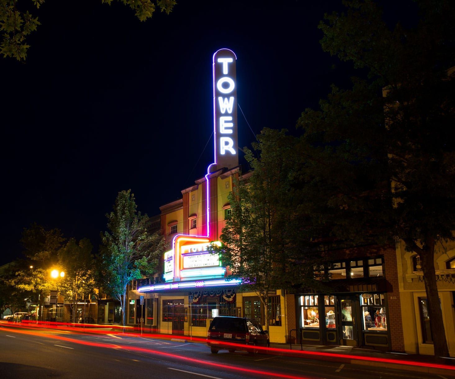 The tower theater is lit up at night