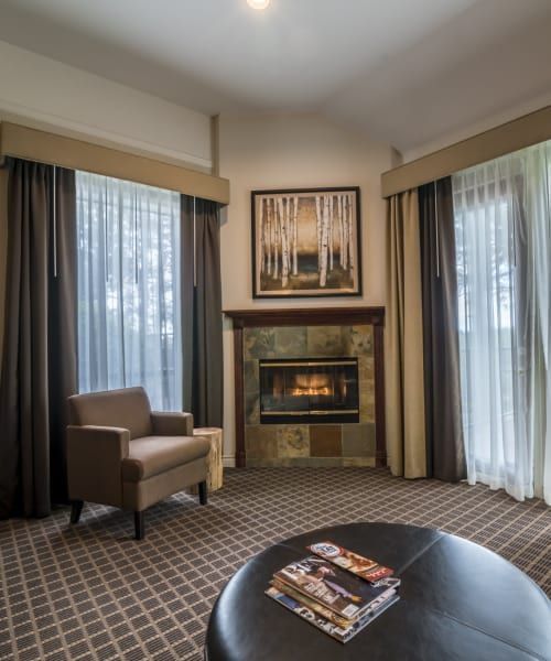 A living room with a fireplace and a chair