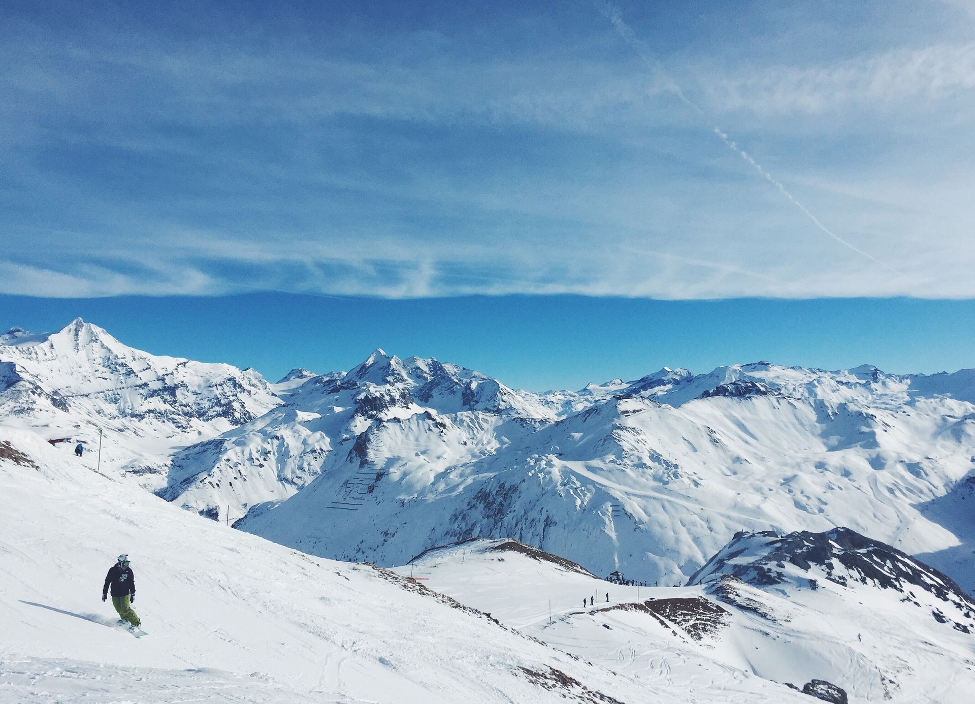 A person is skiing down a snow covered mountain.