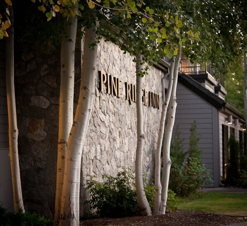 A stone wall with the word pine on it