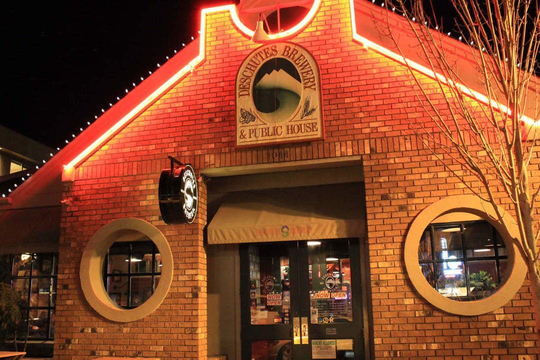 A brick building with a sign on it that says ' chicken coop '