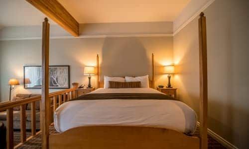 There is a four poster bed in the middle of the room.