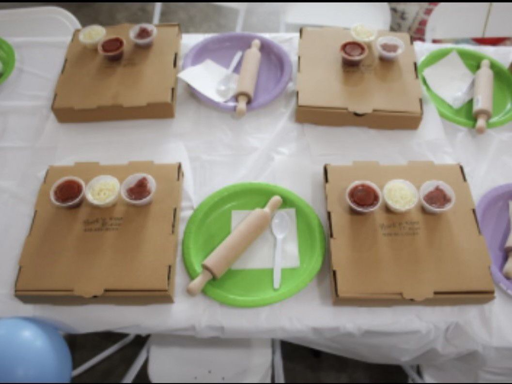A long table with plates and balloons on it