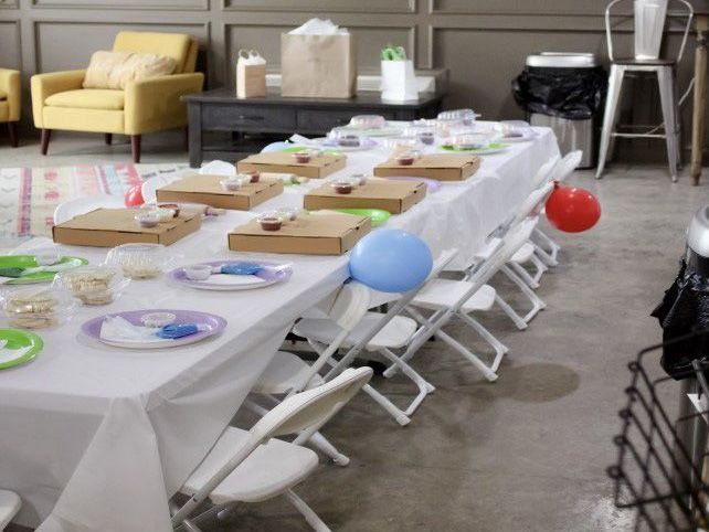 A long table with plates and balloons on it