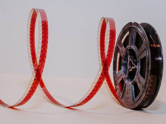 A close up of a film reel on a white surface